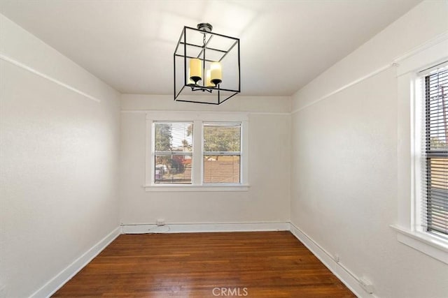 unfurnished dining area featuring dark hardwood / wood-style flooring