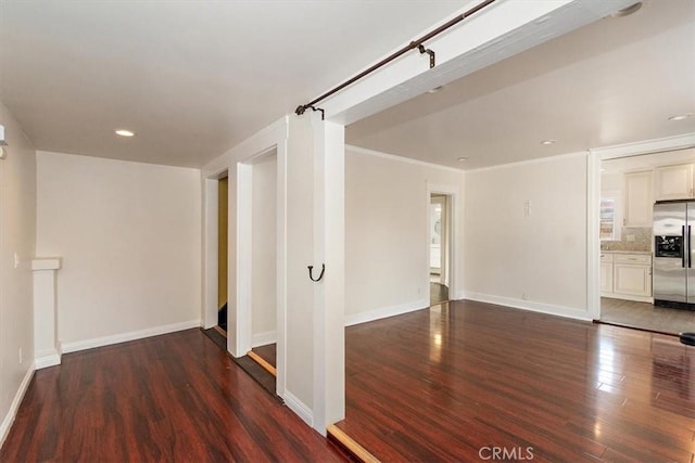 corridor featuring ornamental molding and dark hardwood / wood-style floors