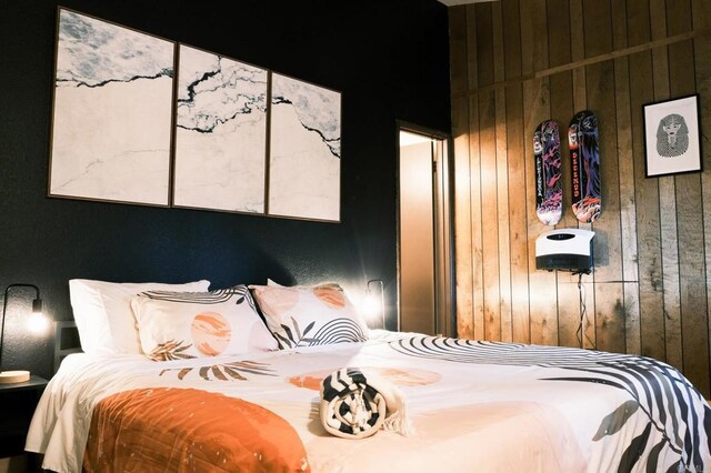 bedroom with wood walls