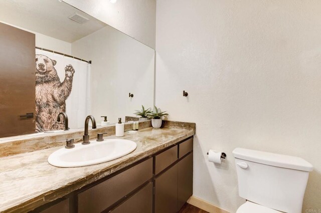 bathroom featuring toilet and vanity