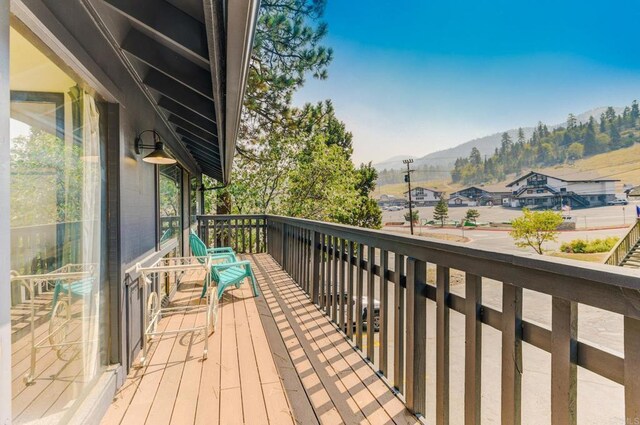 wooden deck featuring a mountain view