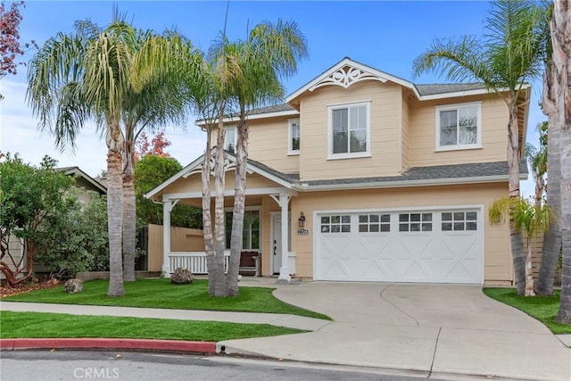 craftsman-style home featuring a front yard, covered porch, and a garage