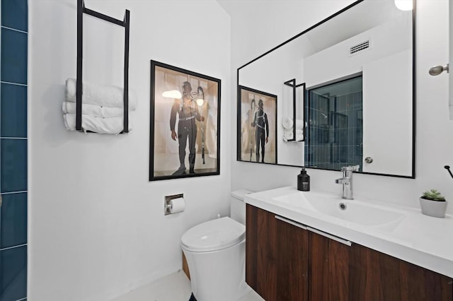 bathroom featuring toilet and vanity