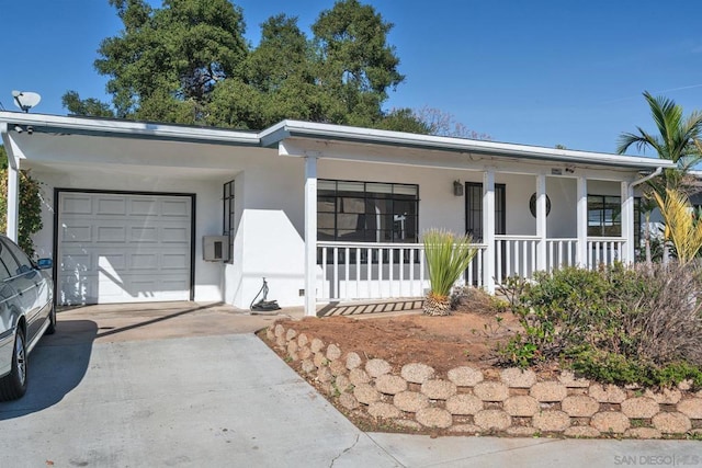 ranch-style home featuring a garage and a porch