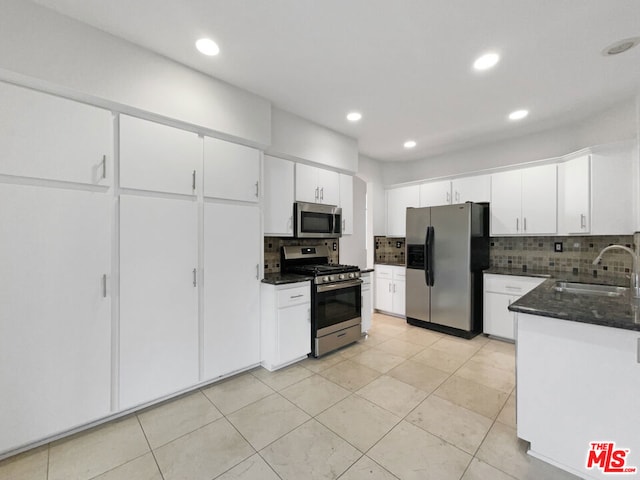 kitchen with sink, white cabinets, stainless steel appliances, and tasteful backsplash