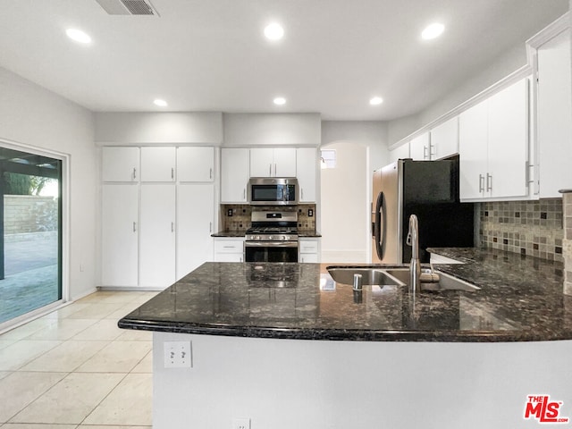 kitchen featuring white cabinets, kitchen peninsula, sink, and stainless steel appliances