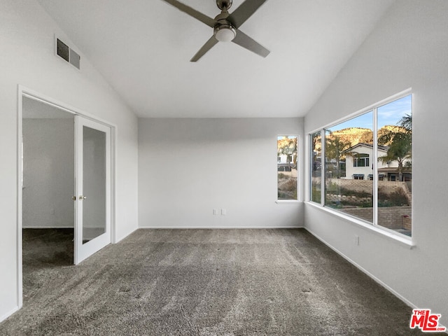 unfurnished sunroom with ceiling fan, vaulted ceiling, and french doors