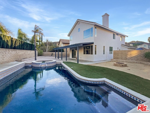 view of swimming pool featuring a patio area, an in ground hot tub, a lawn, an outdoor fire pit, and a pergola