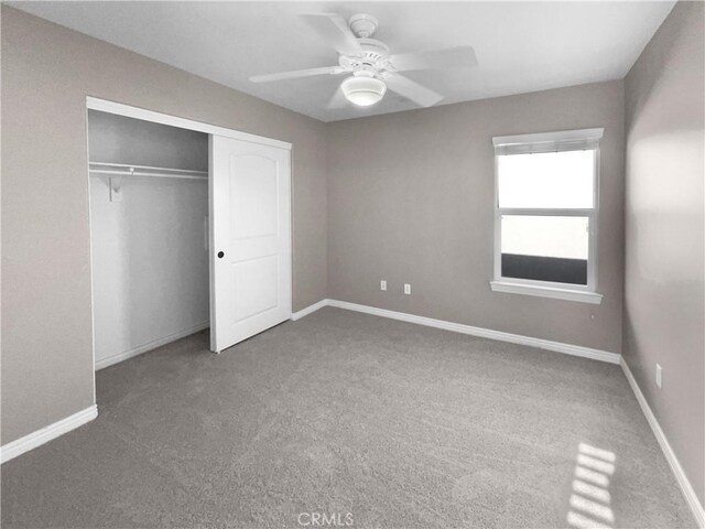 unfurnished bedroom featuring ceiling fan, carpet, and a closet