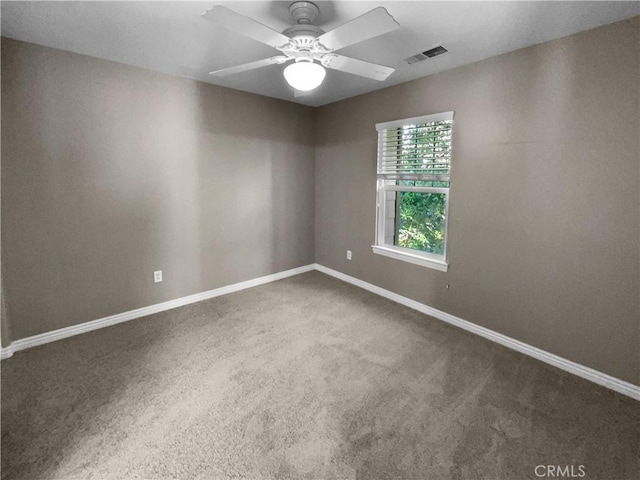 carpeted spare room with ceiling fan