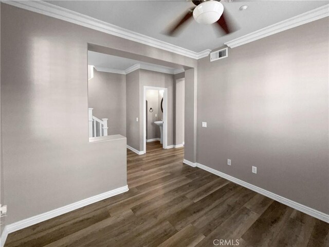 spare room with ceiling fan, dark hardwood / wood-style flooring, and crown molding