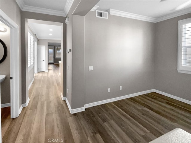 hall with crown molding and hardwood / wood-style floors