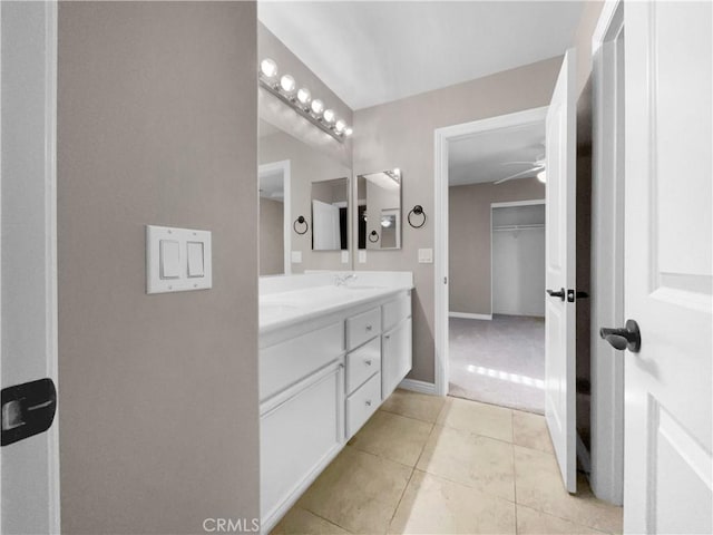 bathroom with ceiling fan, tile patterned floors, and vanity