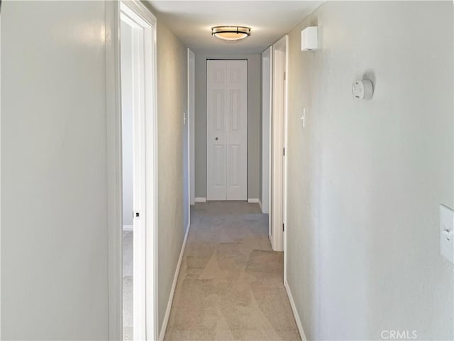 corridor with light colored carpet