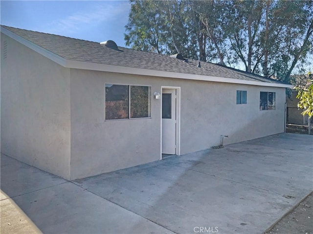 view of side of property with a patio