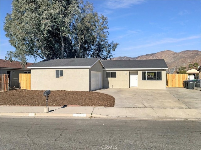 single story home featuring a mountain view and a garage