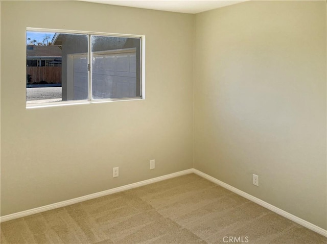 unfurnished room featuring a wealth of natural light and carpet flooring