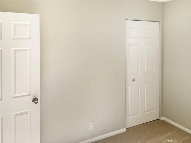 empty room featuring light colored carpet