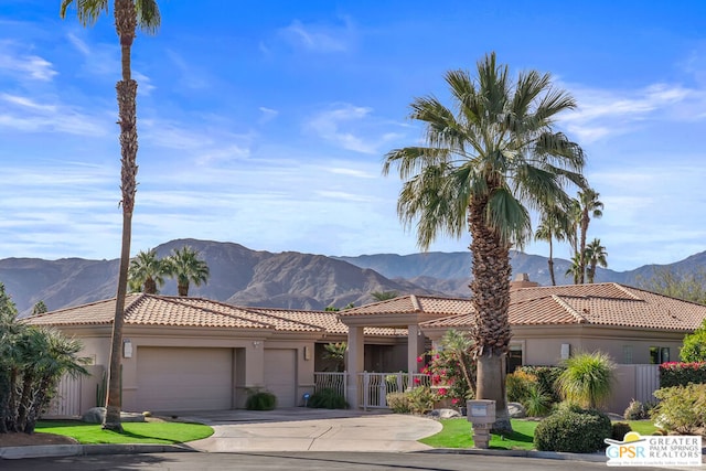 view of front of home with a mountain view and a garage