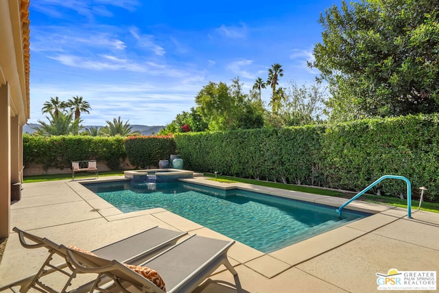 view of pool with an in ground hot tub and a patio