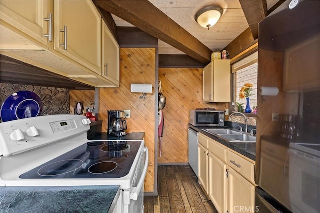 kitchen with wood walls, sink, beam ceiling, and stainless steel appliances