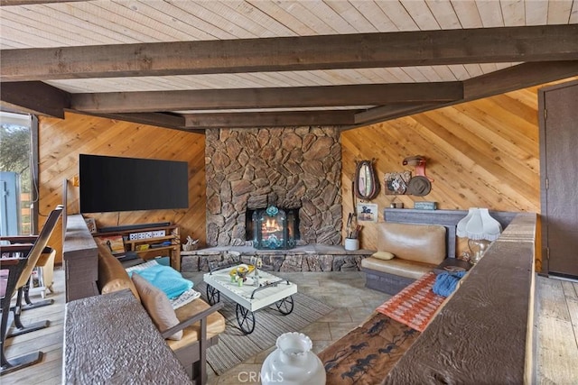 unfurnished living room featuring a fireplace, wood ceiling, beamed ceiling, and wood walls