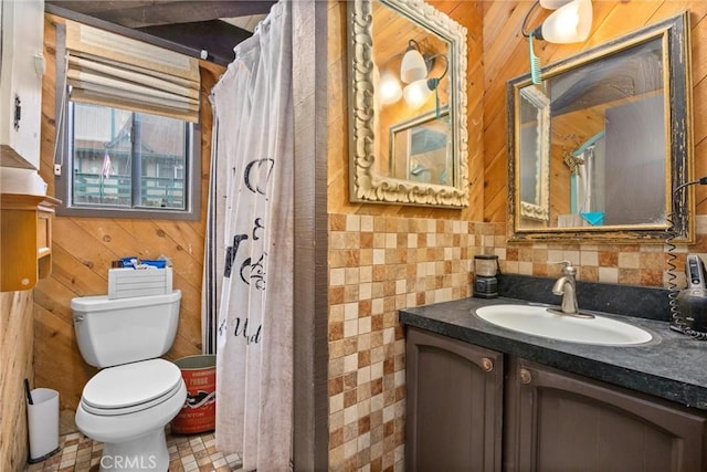 bathroom featuring toilet, vanity, wooden walls, and walk in shower