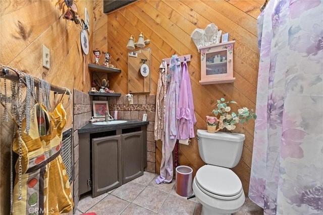 bathroom with vanity, tile patterned floors, and wooden walls