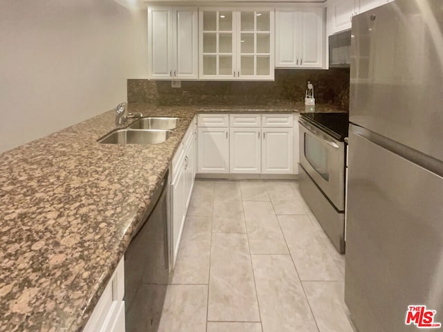 kitchen with decorative backsplash, sink, white cabinetry, and appliances with stainless steel finishes