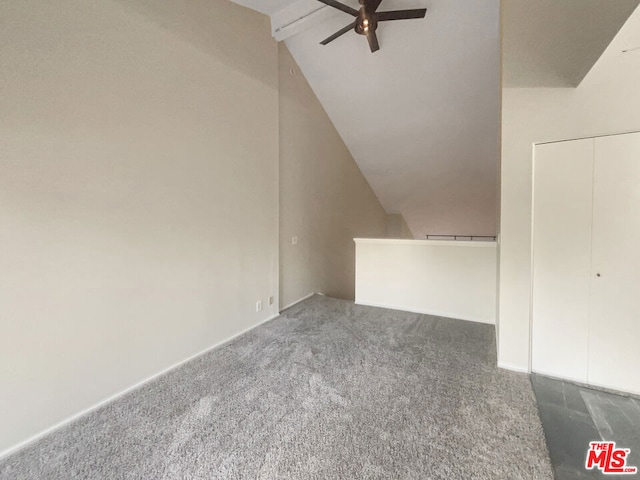 additional living space featuring ceiling fan, vaulted ceiling with beams, and dark colored carpet