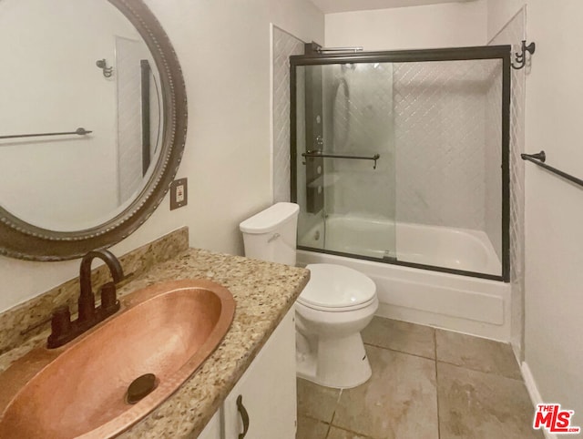 full bathroom with toilet, vanity, tile patterned flooring, and shower / bath combination with glass door