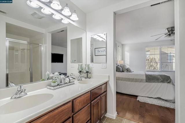 bathroom with tile patterned floors, ceiling fan, walk in shower, and vanity