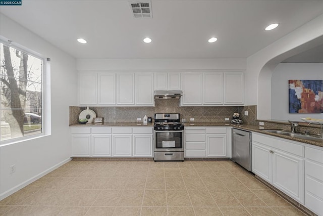 kitchen featuring white cabinets, dark stone countertops, sink, and stainless steel appliances