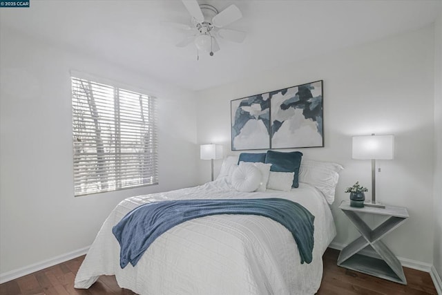 bedroom with dark hardwood / wood-style floors and ceiling fan