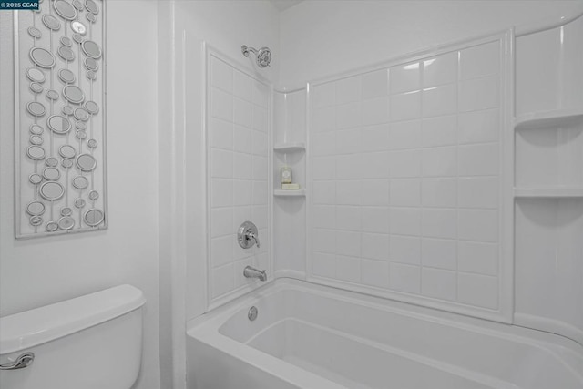 bathroom with washtub / shower combination and toilet