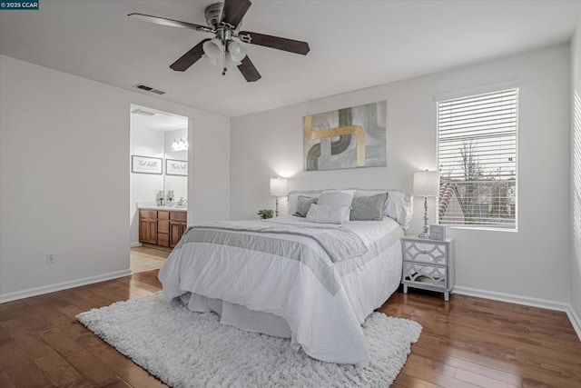 bedroom with wood-type flooring, ensuite bath, and ceiling fan