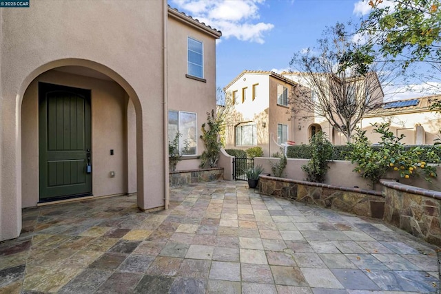 entrance to property featuring a patio