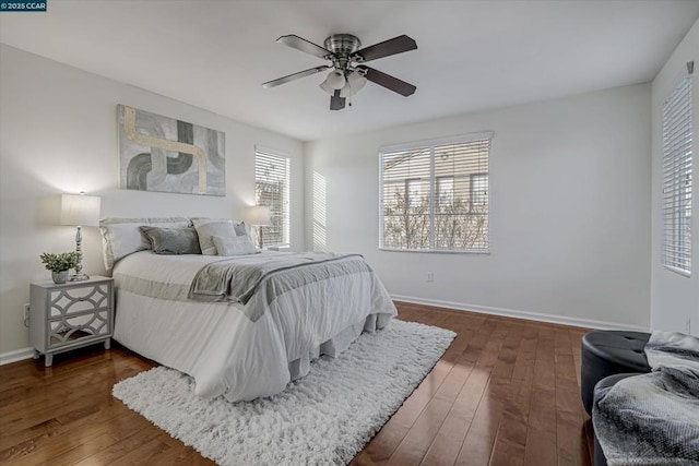 bedroom with ceiling fan and dark hardwood / wood-style flooring