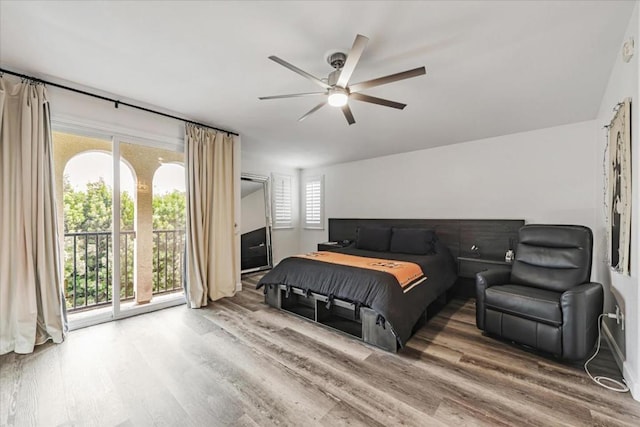 bedroom featuring ceiling fan, access to exterior, and hardwood / wood-style floors