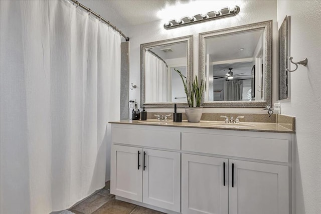 bathroom with ceiling fan and vanity