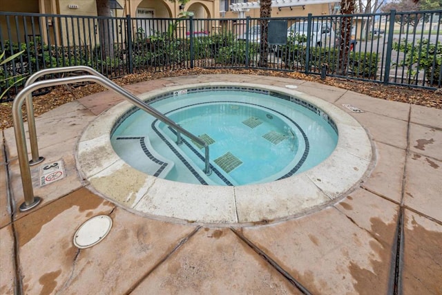 view of pool with a hot tub