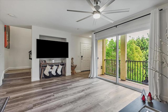 living room featuring ceiling fan and hardwood / wood-style flooring