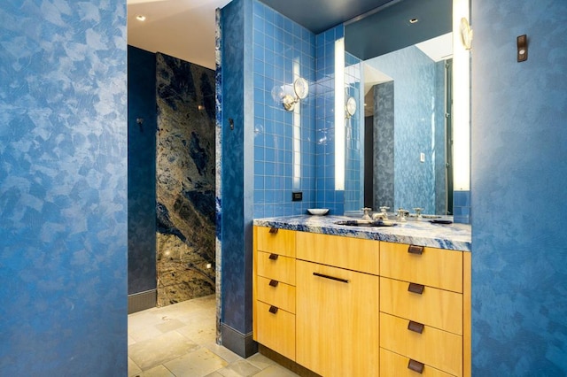 bathroom with tile walls and vanity