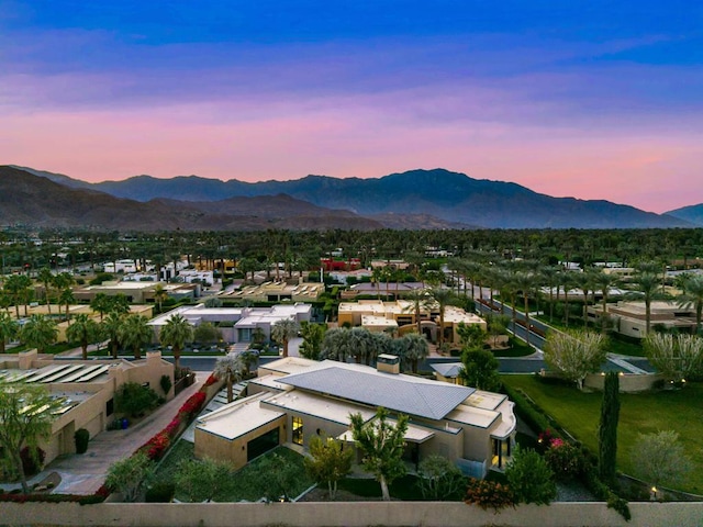 aerial view at dusk featuring a mountain view