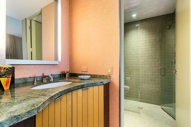 bathroom featuring an enclosed shower, vanity, and tile patterned flooring