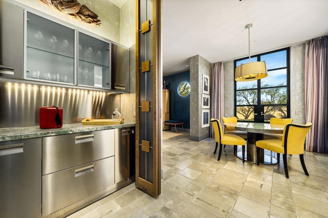 kitchen featuring decorative light fixtures and stone counters