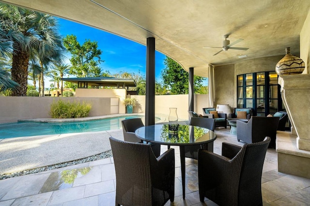 view of patio / terrace featuring ceiling fan and a fenced in pool