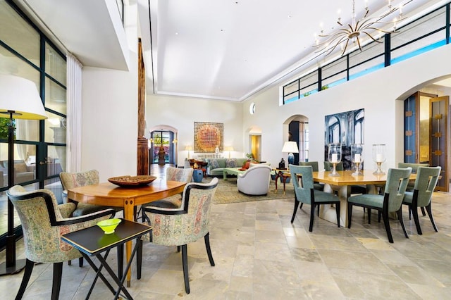 dining room featuring a wealth of natural light and a towering ceiling