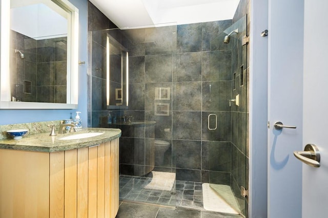 bathroom featuring walk in shower, vanity, and toilet