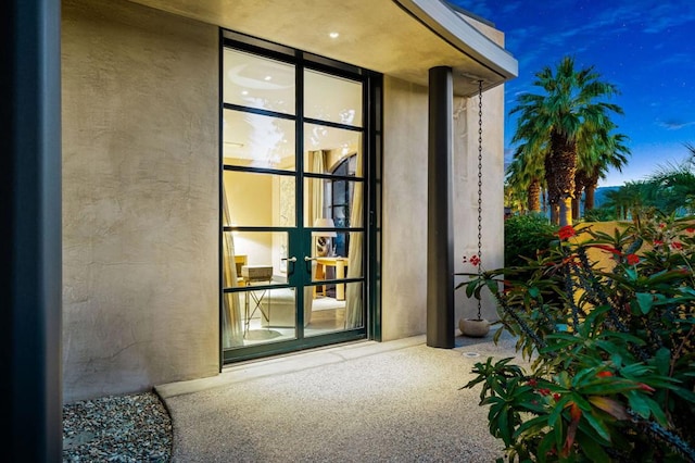 exterior entry at dusk featuring french doors